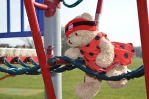 A teddy bear sitting on top of a pole