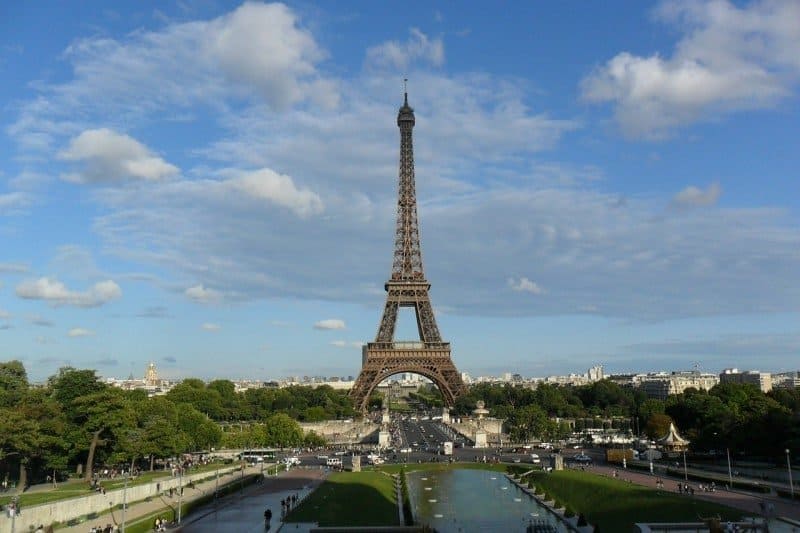 A large clock tower towering over Eiffel Tower