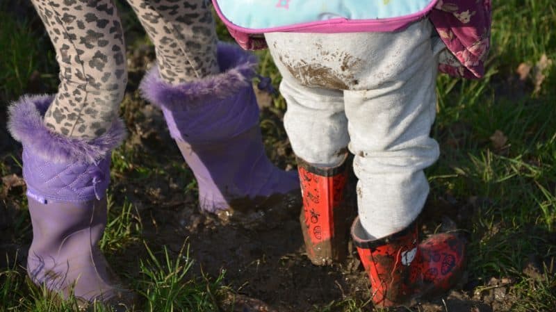 A little girl that is standing in the grass