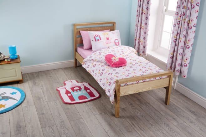 A bedroom with a stuffed animal on a table