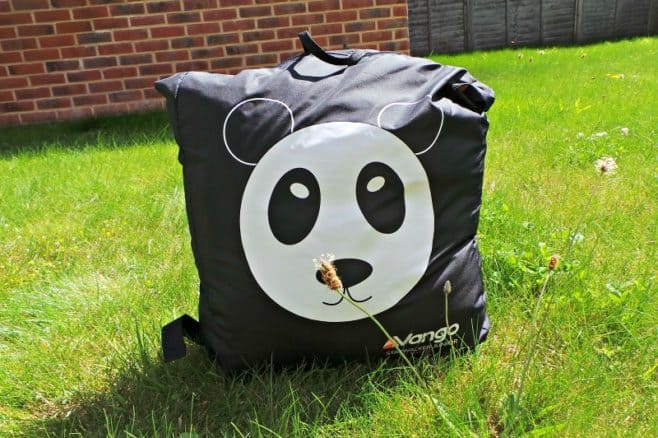 A bag sitting on top of a grass covered field