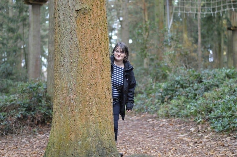 A person standing next to a tree