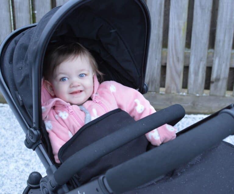 A little girl sitting on a suitcase