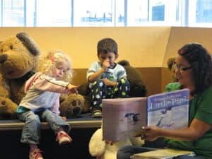 A group of stuffed animals sitting next to a man