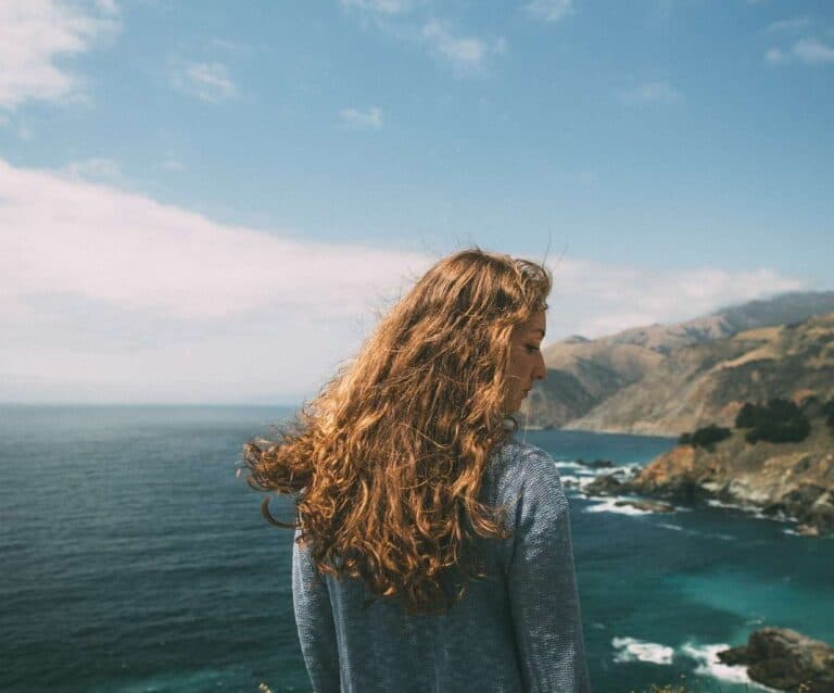 A person standing in front of a body of water