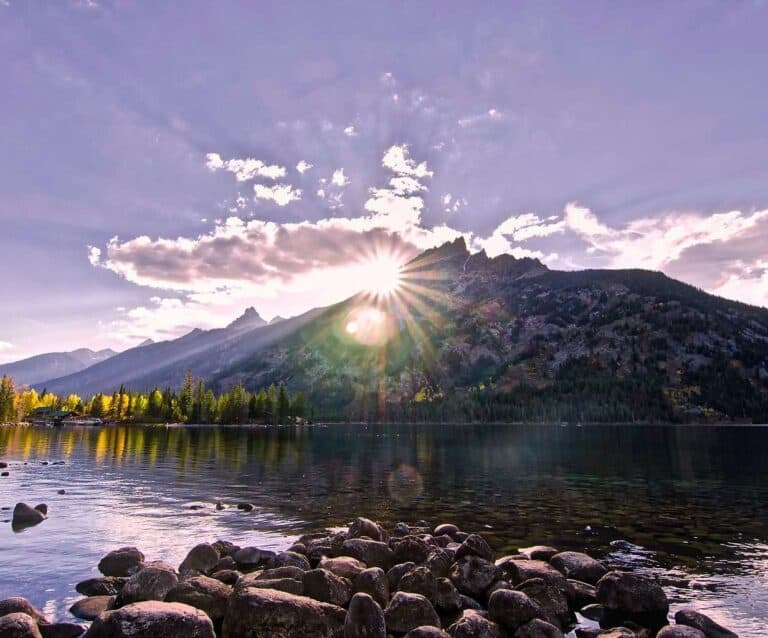 A large body of water with a mountain in the background