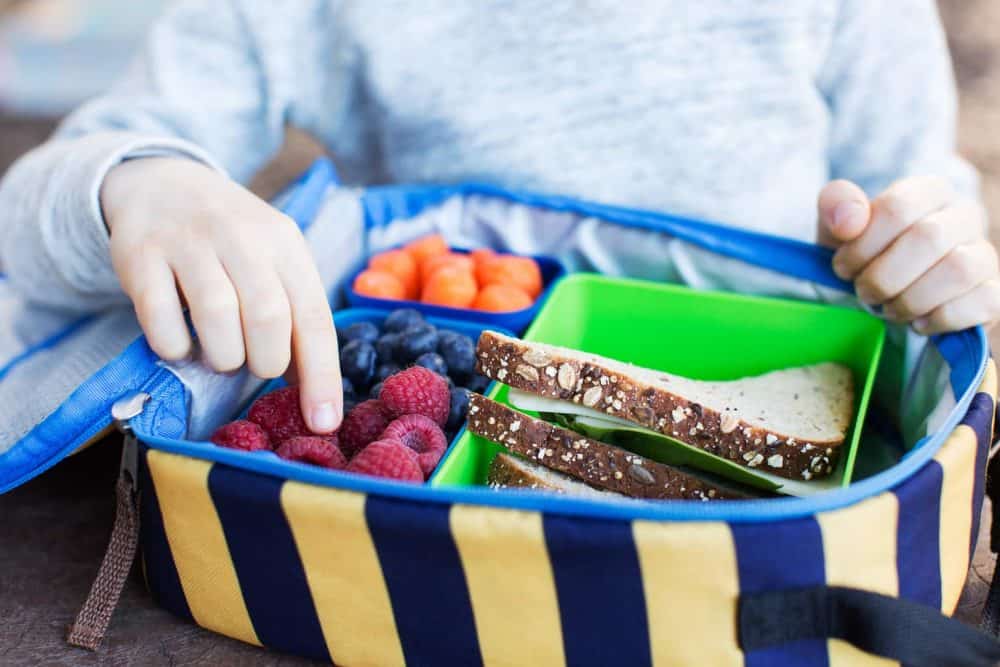 A small child in a blue bowl, with Lunch and School - Tips to help you beat the school run rush