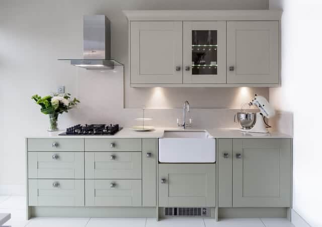 A kitchen with a sink and a mirror