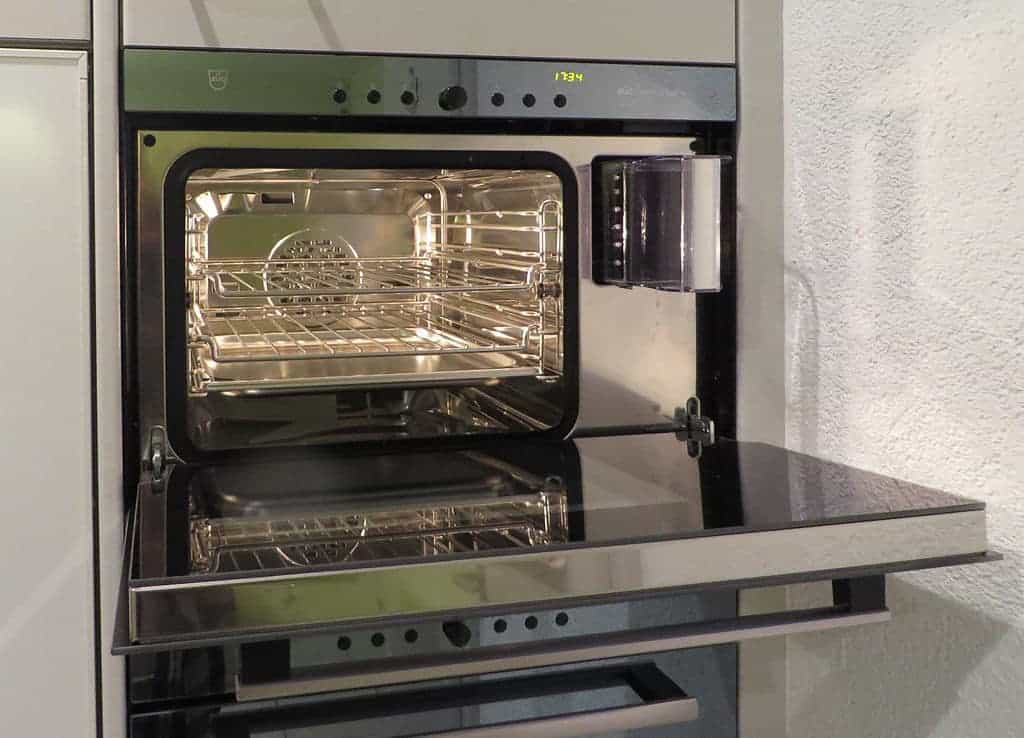 A microwave oven sitting on top of a stove