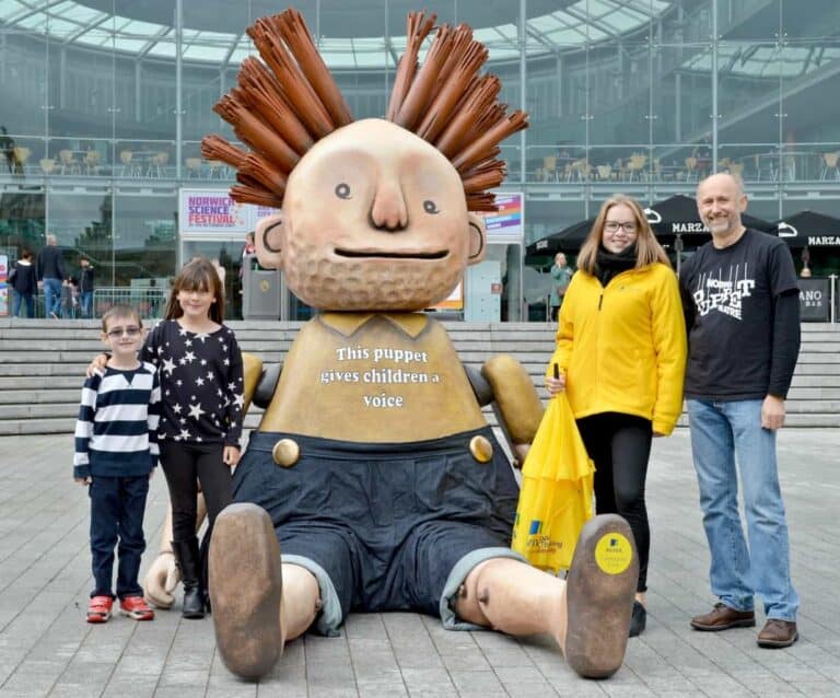 A group of people standing in front of a statue