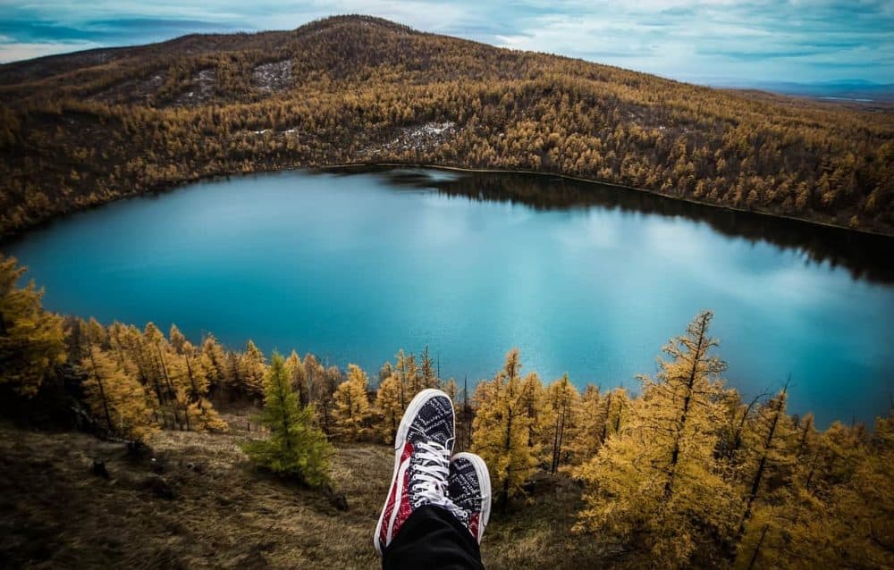 A body of water with a mountain in the background