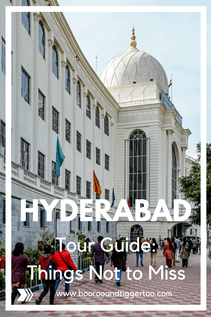 A group of people walking in front of Salar Jung Museum