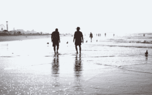 A group of people walking on a beach