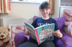 A young boy is reading a book