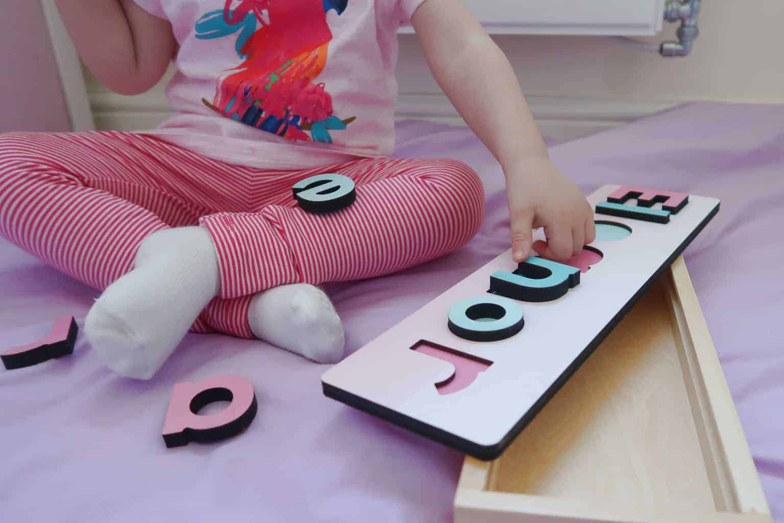 A little girl sitting on a bed