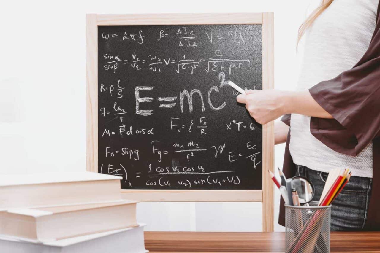 A person standing in front of a blackboard