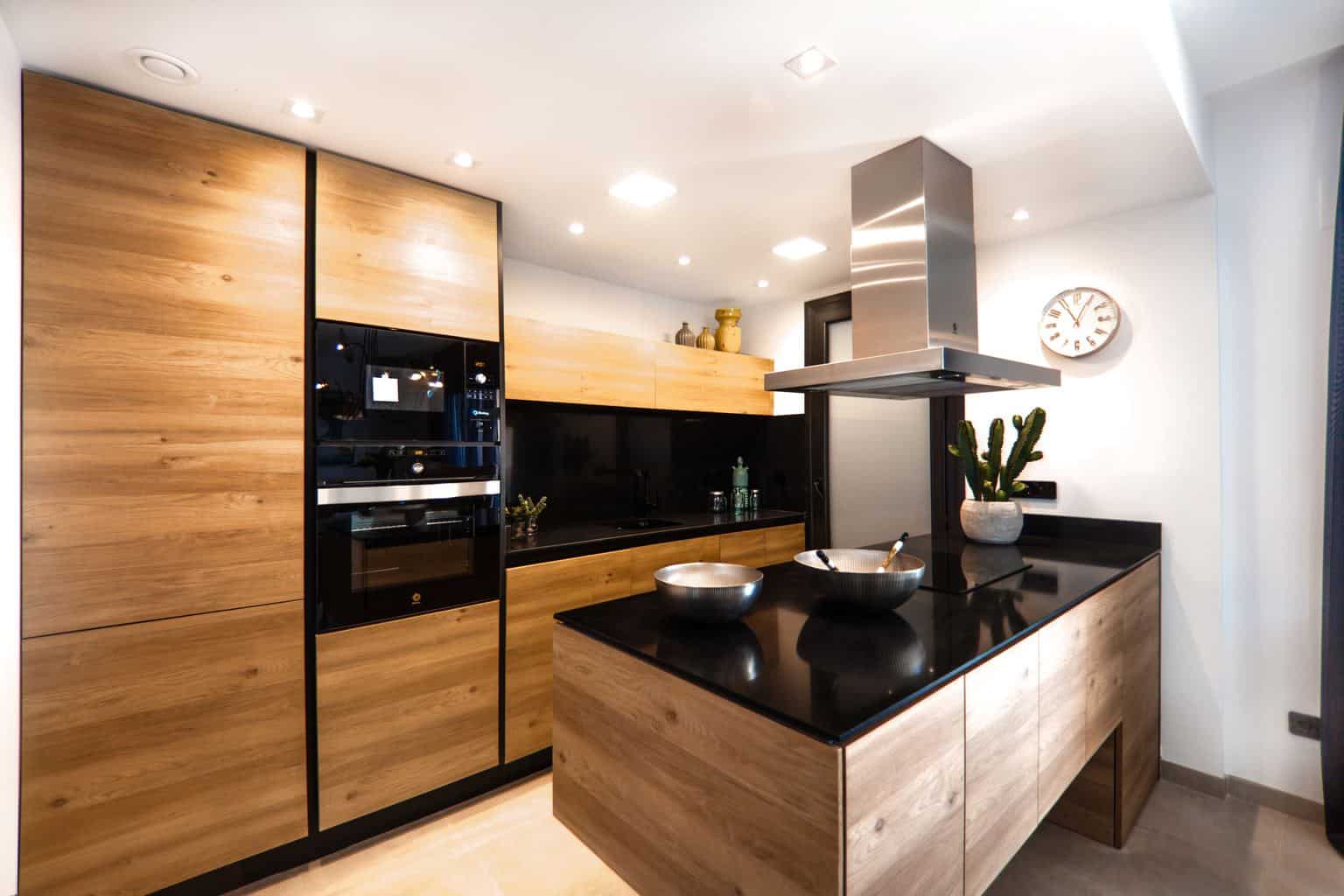 A modern kitchen with stainless steel appliances and wooden cabinets