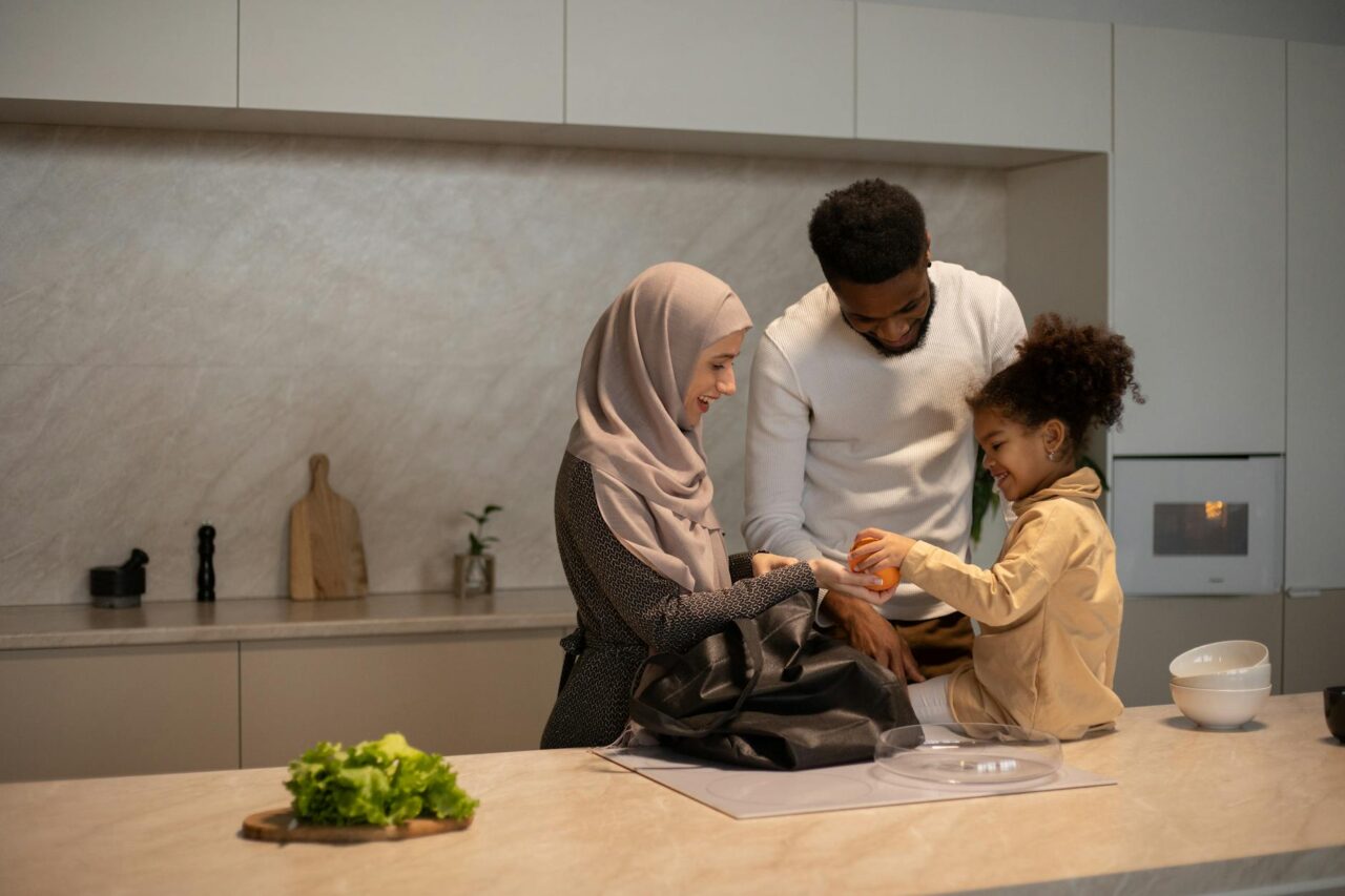 happy multiethnic family near table in kitchen