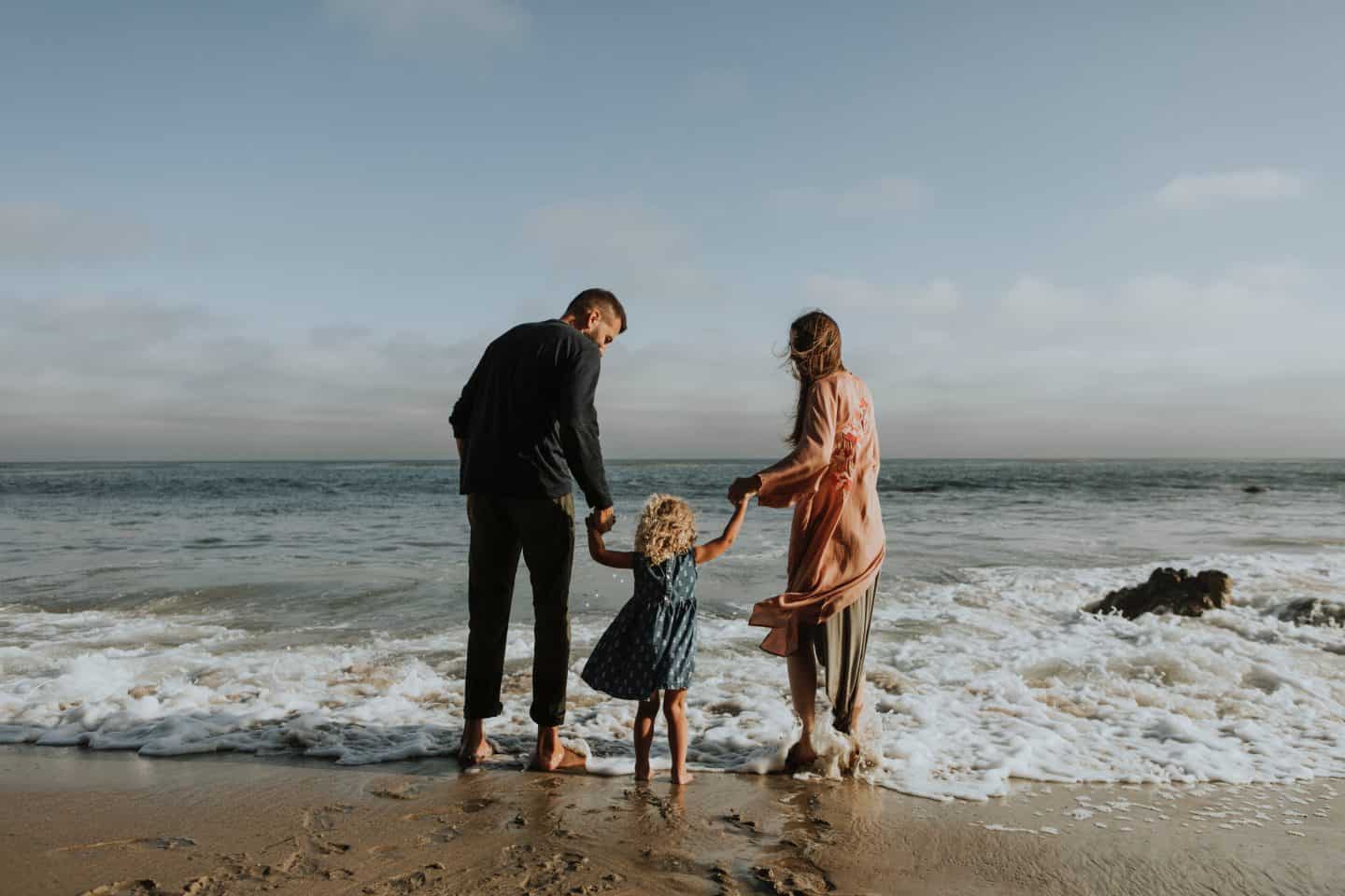 A man and a woman standing on a beach