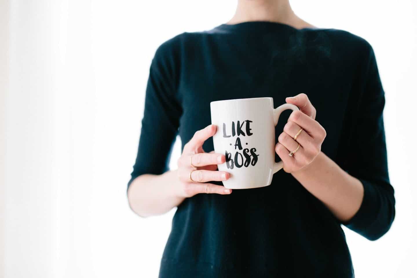 A person holding a coffee mug, with Job and Business