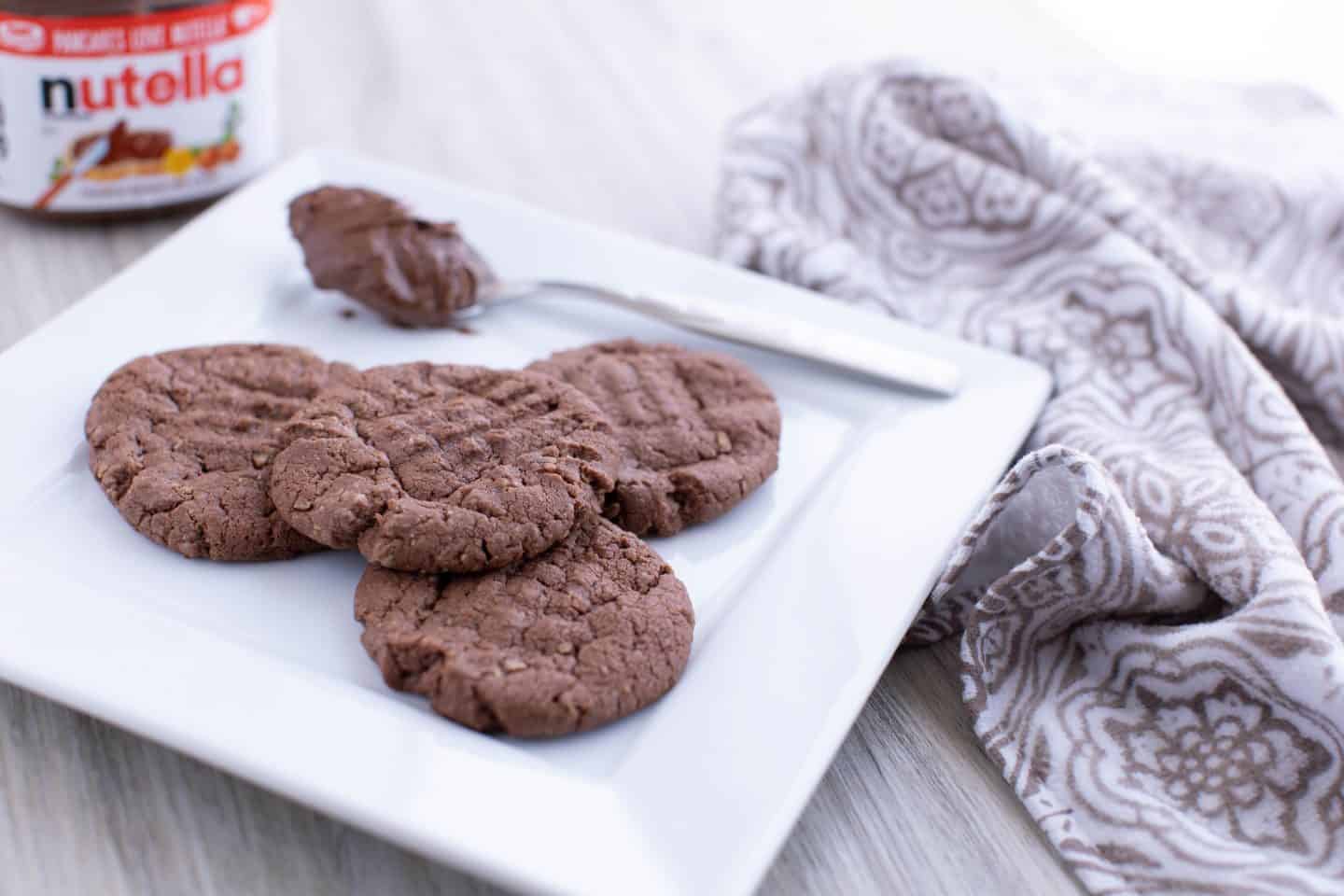 A piece of cake on a plate, with Cookie and Nutella