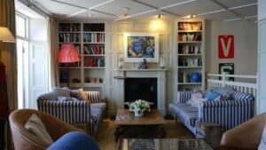 A living room filled with furniture and a fire place sitting in a chair