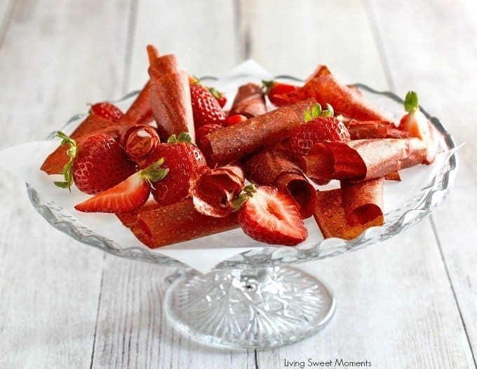 A plate of food with a slice of cake on a table, with Strawberry and Snack