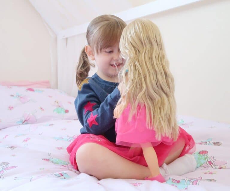 A little girl sitting on a bed