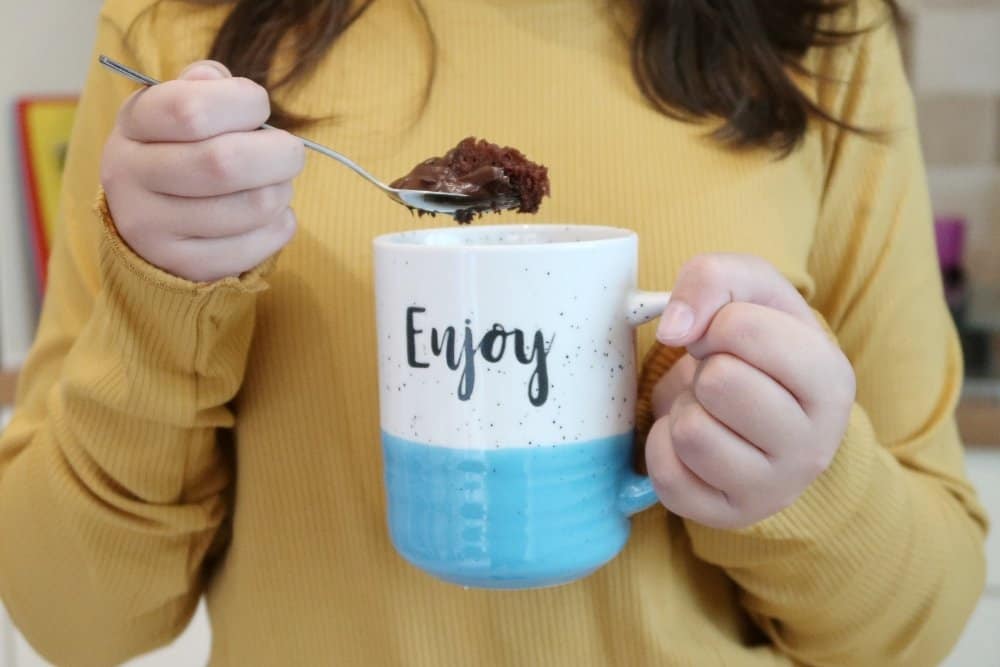 A woman drinking from a cup