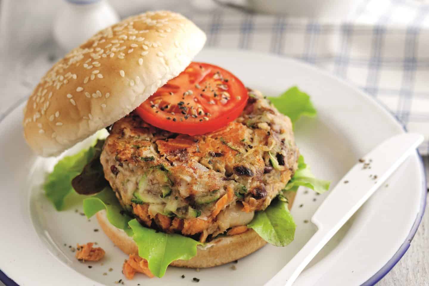 A sandwich on a plate, with Salmon and Salmon burger