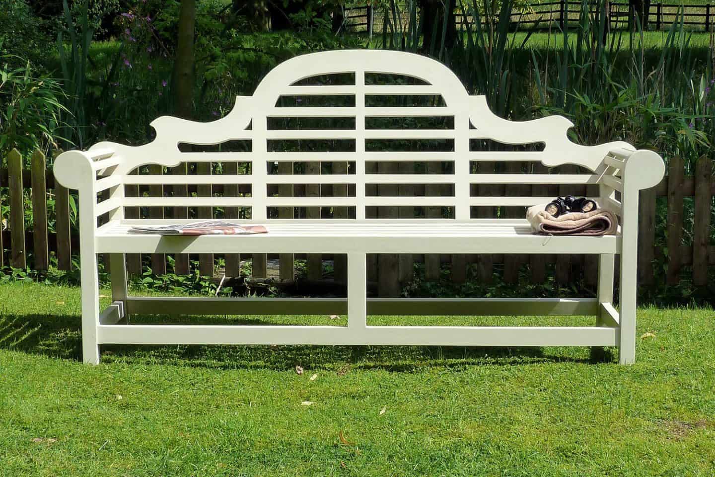 A couple of lawn chairs sitting on top of a wooden bench