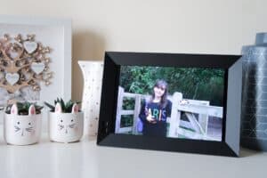 A digital photo frame is sitting on a table