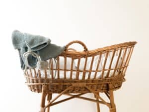 wicker moses basket with grey blanket
