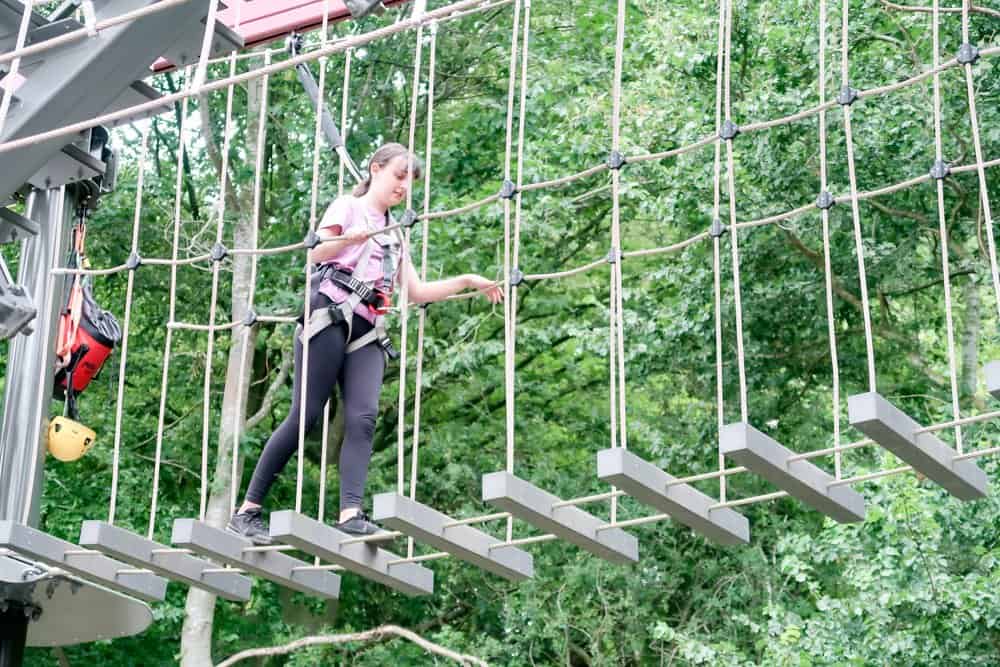 teenager completing a high ropes course