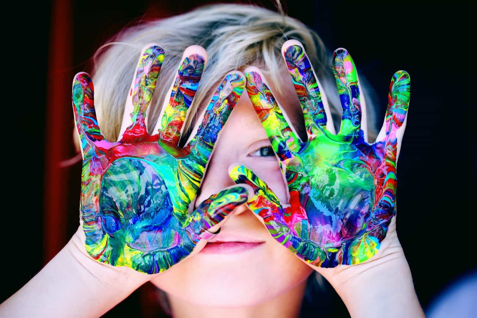 Signs Your Child Might Have Lead Poisoning | a kid with multicoloured hand paint