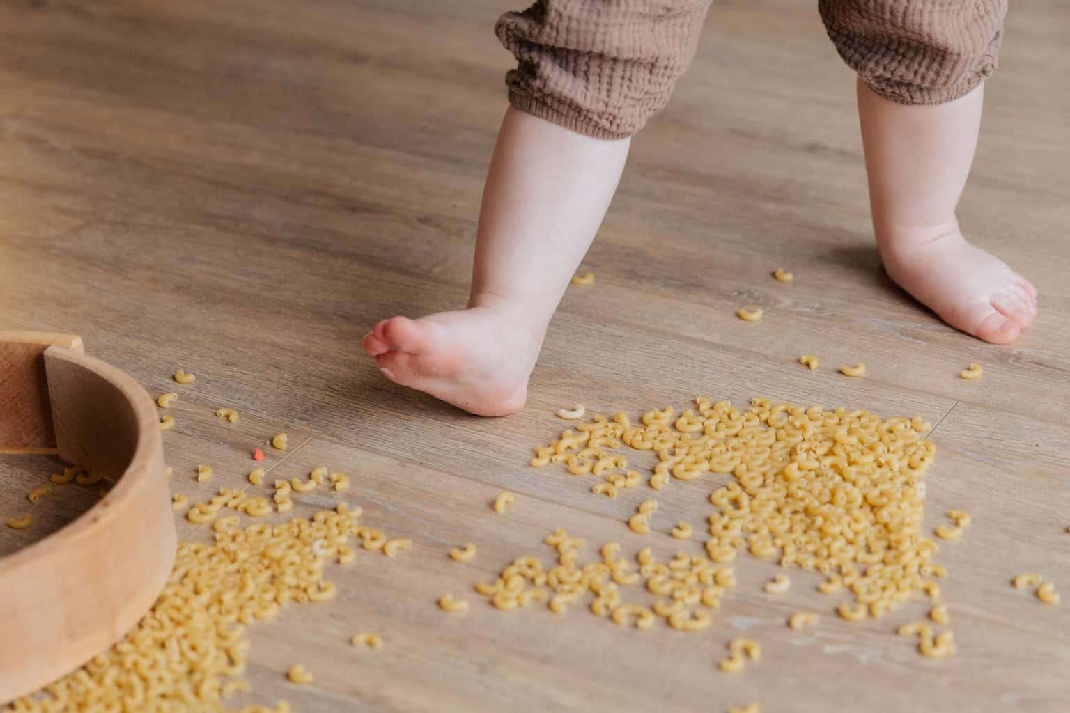 What are the benefits of sensory play for your child’s development? - child stepping on macaroni