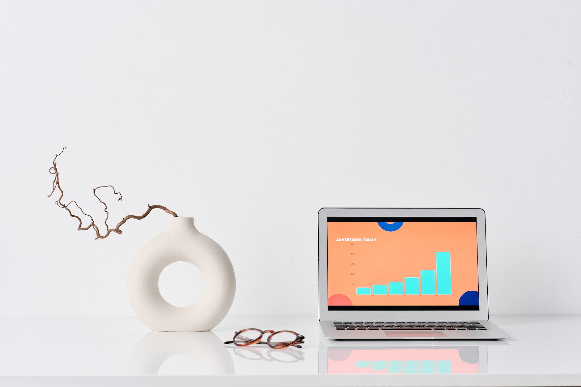 laptop beside a ceramic vase - Easy Steps to Creating an Influencer Marketing Strategy