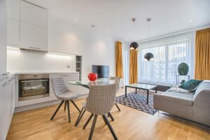 two chairs with glass table on living room near window