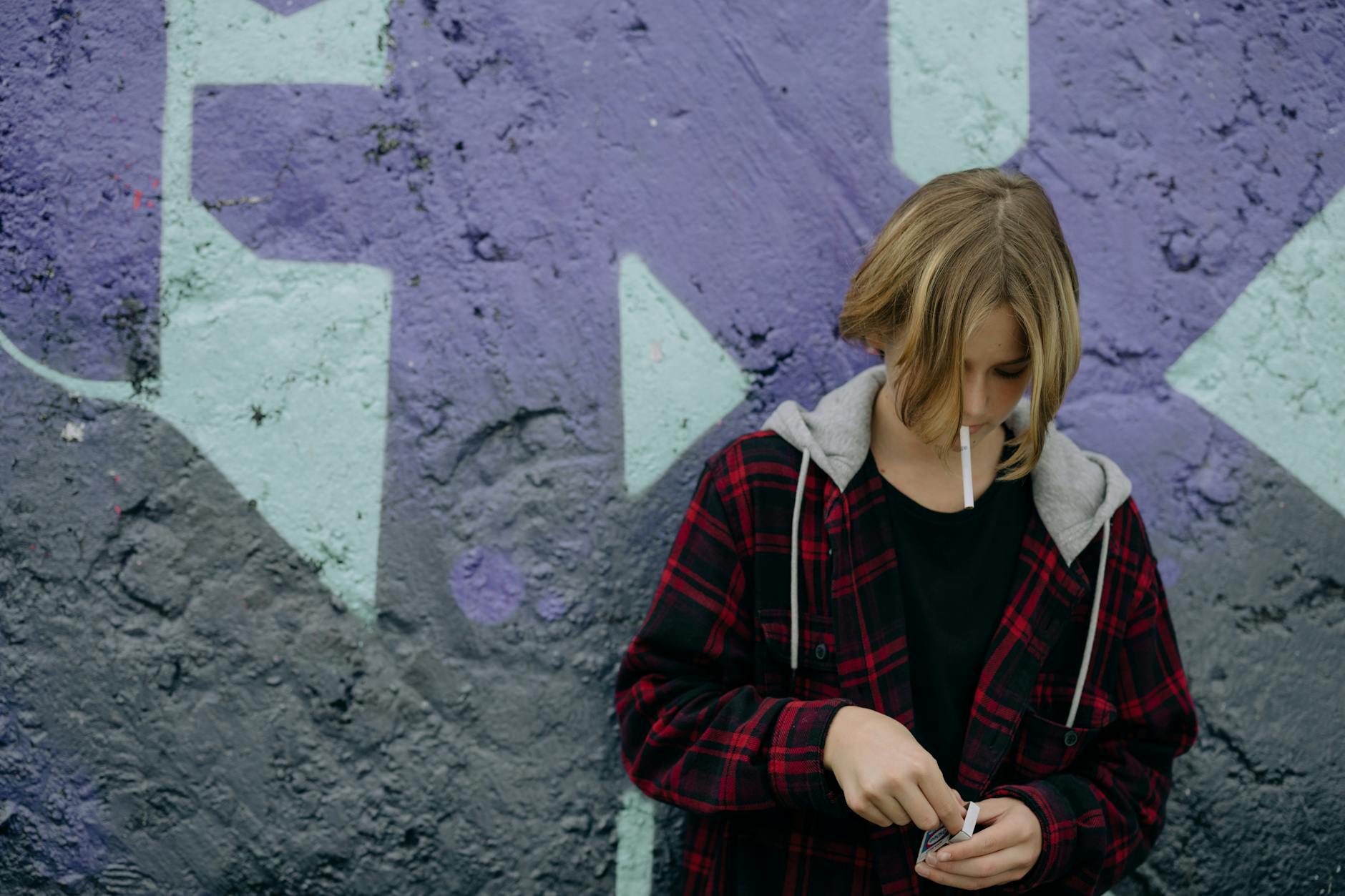 a teenager with a cigarette