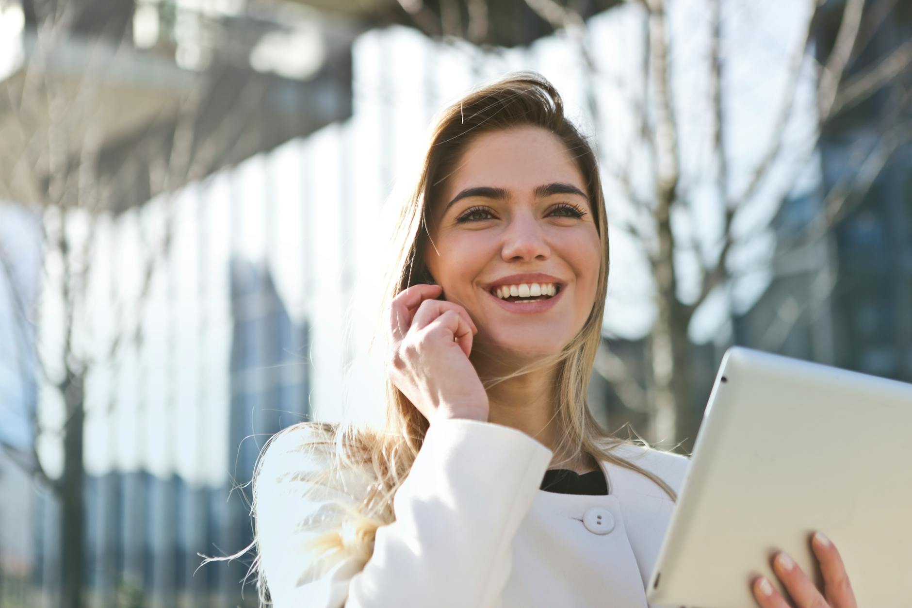 woman in white blazer holding tablet computer - Navigating Career Choices: Essential Tools and Strategies