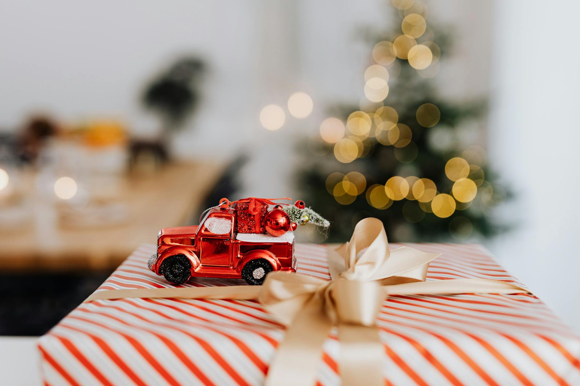 a toy car on top of a christmas present