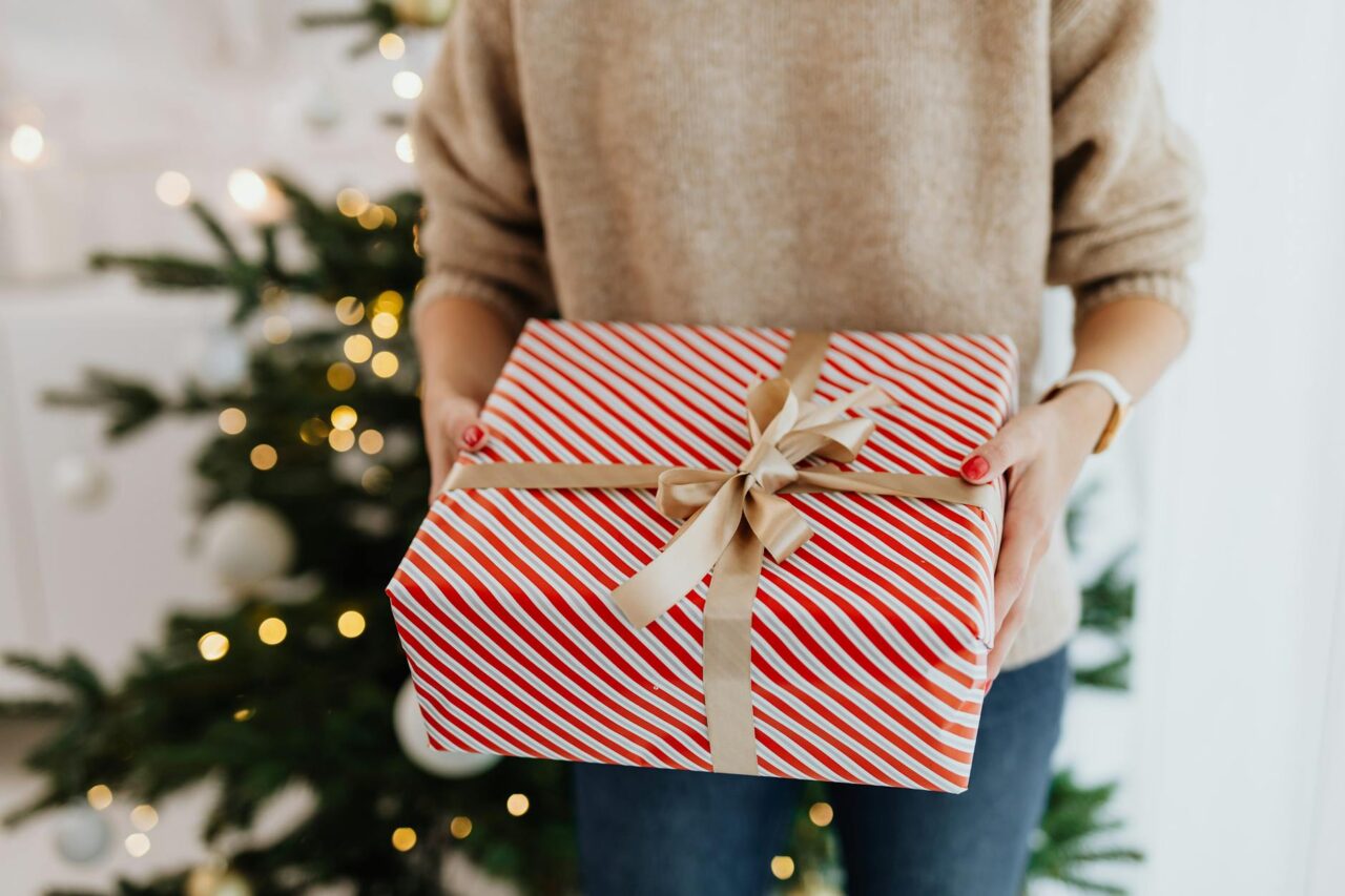 close up shot of a person holding a christmas present